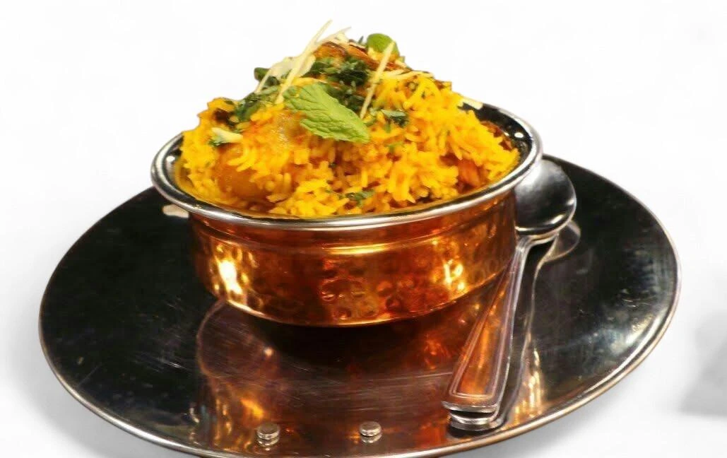 Fragrant chicken biryani with basmati rice at Hot Mug Cafe in Edmonton